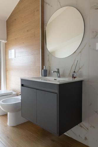a bathroom with a sink and a toilet and a mirror at B&B Sila in Fiore in San Giovanni in Fiore