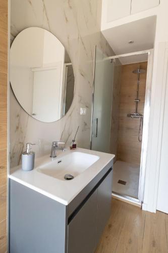 a white bathroom with a sink and a mirror at B&B Sila in Fiore in San Giovanni in Fiore