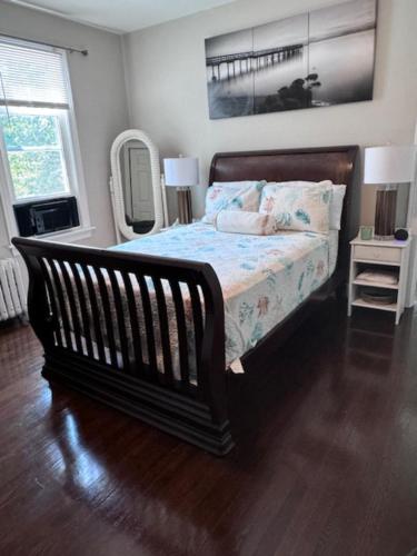 a bedroom with a bed and a mirror at Bloom Victorian Bed & Breakfast in South Orange