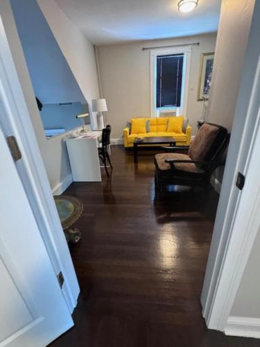 a view of a living room with a yellow couch at Bloom Victorian Bed & Breakfast in South Orange