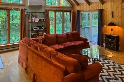 a living room with a couch and a glass table at Secluded Mountain House in Forest Farms