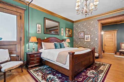 a bedroom with a bed and a chair and a mirror at The Audrey - Springfield in Springfield