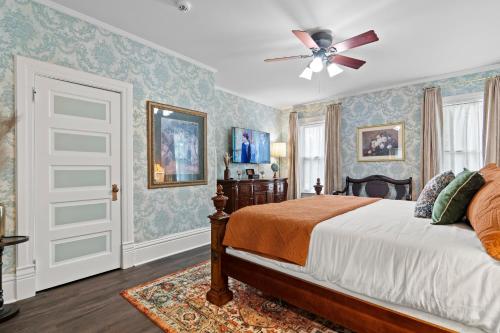 a bedroom with a bed and a ceiling fan at The Audrey - Springfield in Springfield