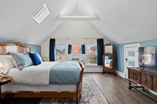 a bedroom with a bed and a flat screen tv at The Audrey - Springfield in Springfield