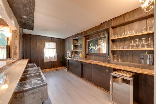 a room with wooden walls and shelves with glasses at Pet-Friendly Home with Game Room in Hillsgrove! in Hillsgrove