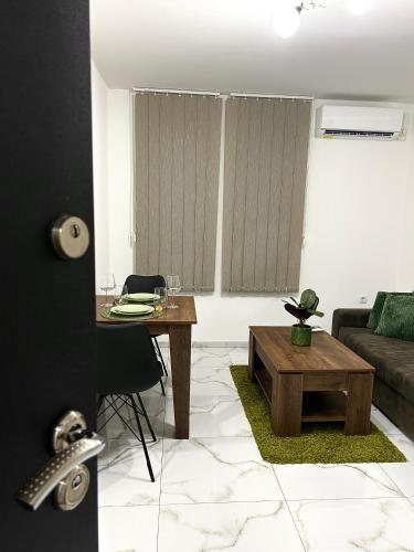 a living room with a table and a couch at Millie's apartments in Ćuprija