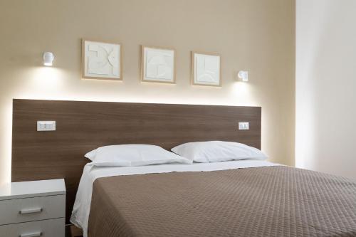 a bedroom with a large bed with two pillows at B&B Sila in Fiore in San Giovanni in Fiore