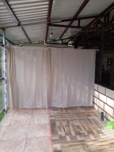 a room with a white curtain on the floor at Casa Lapas. in Aguas Zarcas