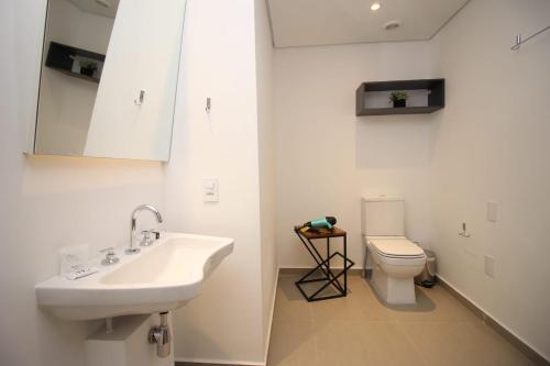 a bathroom with a sink and a toilet at 360 VN Turiassú by Housi in Sao Paulo