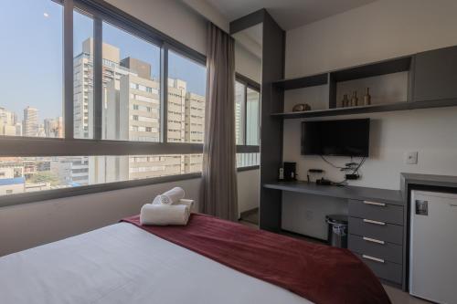 a bedroom with a large bed with a large window at 360 VN Turiassú by Housi in Sao Paulo