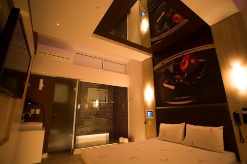 a small bedroom with a bed and a window at Audace Motel in Porto Alegre
