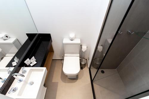 a bathroom with a toilet and a sink and a shower at 360 VN Turiassú by Housi in Sao Paulo