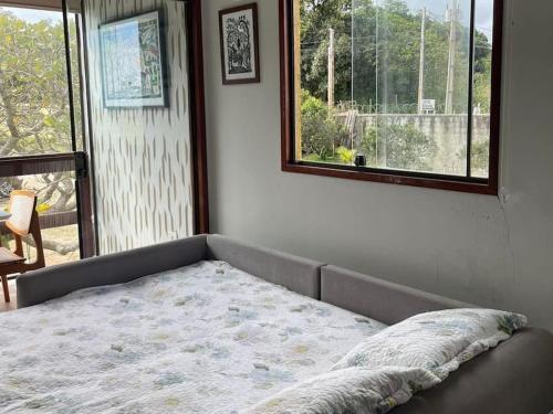 a bed sitting in a room with a window at Flat Serra Negra, Bezerros in Bezerros