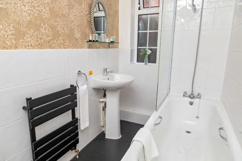 a bathroom with a sink and a bath tub and a sink at G Boutique Hotel in Portsmouth