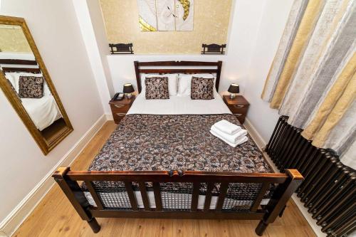 a bedroom with a bed and a mirror at G Boutique Hotel in Portsmouth