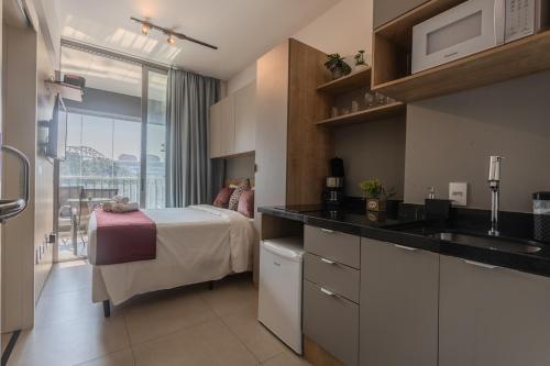 a kitchen with a bed and a sink in a room at 360 VN Turiassú by Housi in Sao Paulo
