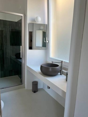 a bathroom with a sink and a large mirror at B&B Dimora Liberty in Genoa