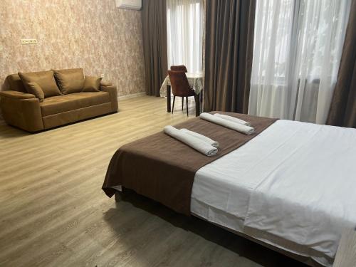 a hotel room with a bed and a couch at Villa for families and friends 4 in Tbilisi City