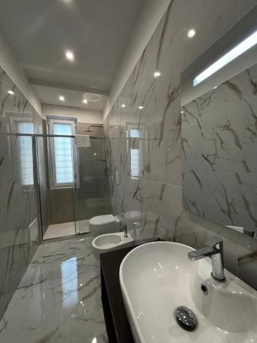 a bathroom with a sink and a shower and a toilet at A Casa di Nina Modern House in Pompei