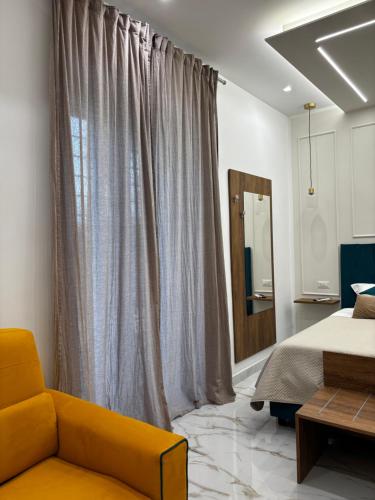 a bedroom with a bed and a yellow couch at A Casa di Nina Modern House in Pompei