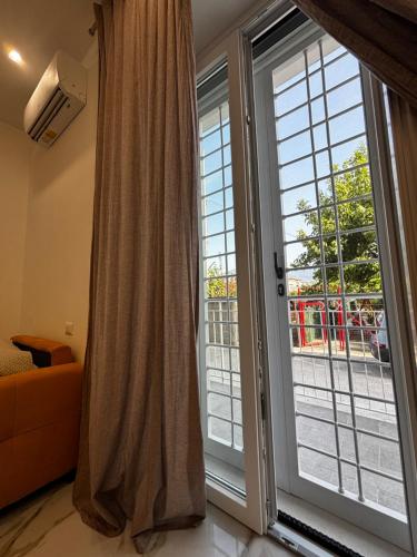 a room with two large sliding doors and a window at A Casa di Nina Modern House in Pompei