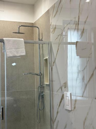 a bathroom with a shower with a glass door at A Casa di Nina Modern House in Pompei