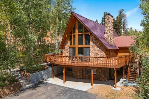 a cabin in the woods with a wrap around deck at Arcade Games Brian Head Resort Newly Renovated in Brian Head