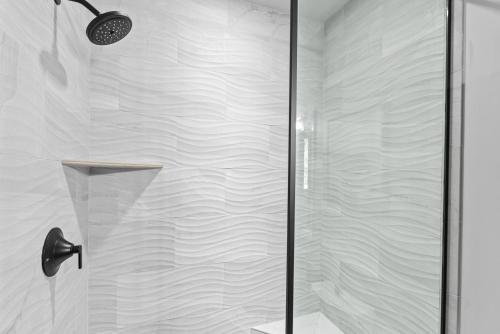 a shower with a glass door in a bathroom at Snowghost Chalet Ultimate Luxury Ski In Ski Out 5BD 55BA with Hot Tubs Steam Room and Game Room in Whitefish