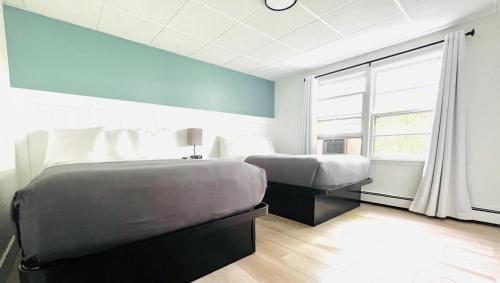 Ένα ή περισσότερα κρεβάτια σε δωμάτιο στο Motel Luzerne