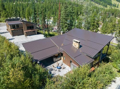 an overhead view of a house with a metal roof at Snowghost Chalet Ultimate Luxury Ski In Ski Out 5BD 55BA with Hot Tubs Steam Room and Game Room in Whitefish