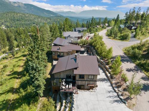 an aerial view of a house in the mountains at Snowghost Chalet Ultimate Luxury Ski In Ski Out 5BD 55BA with Hot Tubs Steam Room and Game Room in Whitefish
