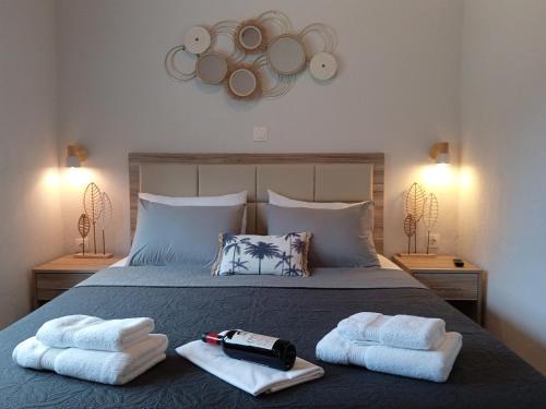 a bedroom with a bed with towels on it at Fish eye in Nikiti