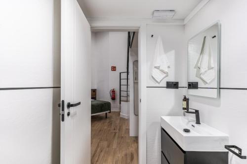 a bathroom with a sink and a mirror at VR OBREGON APARTMENTS in Madrid