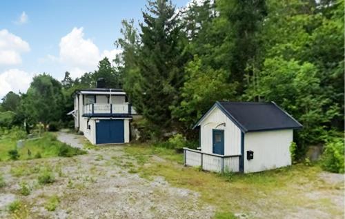 a small white building in a field with trees at 2 Bedroom Nice Home In Ankarsrum in Ankarsrum