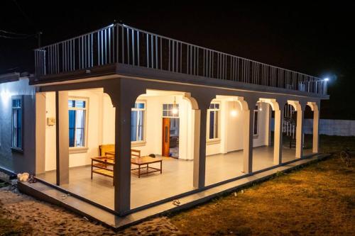 a small building with a deck at night at Bahari Bliss in Makunduchi