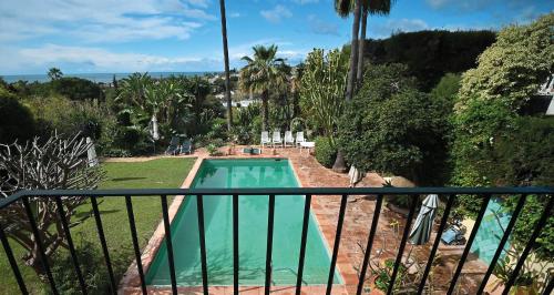 a view of a swimming pool from a balcony at Apartment in elegant villa with pool in Marbella in Marbella