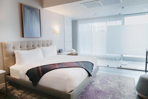 a bedroom with a large bed and a large window at Stanton House El Paso in El Paso