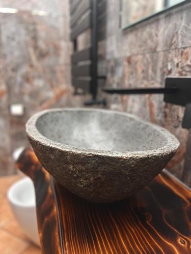 a stone bowl sitting on top of a wooden table at Corte Dei Pini in Modena