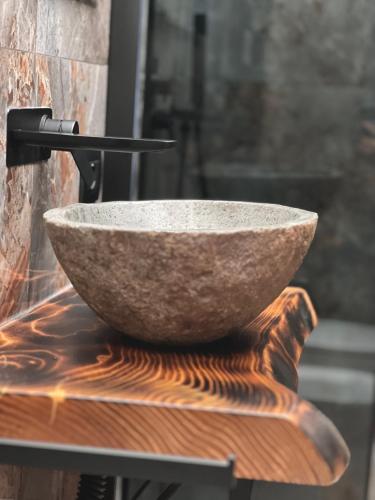 a bowl sitting on top of a wooden table at Corte Dei Pini in Modena