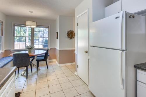 a kitchen with a white refrigerator and a table at Seneca Escape with Screened Patio Near Lakes! in Seneca