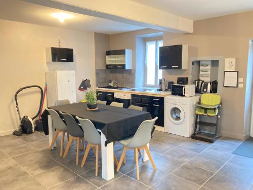 a kitchen with a table and chairs in a kitchen at A&J Family - Neuvy sur Loire - Guédelon in Neuvy-sur-Loire