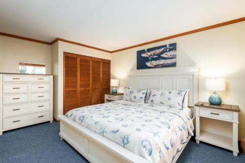 a bedroom with a bed and two night stands at Little Creek Cove Beach Resort in Newport