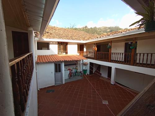 a balcony of a house with a bike on it at Posada Chicara in El Cocuy