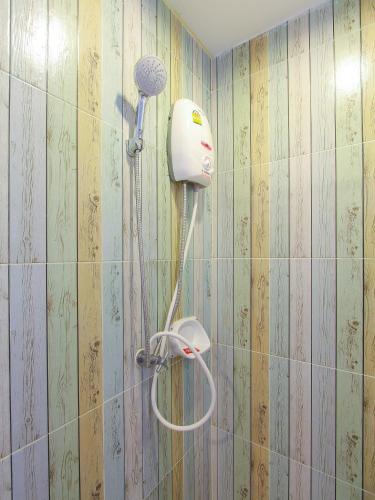 a blow dryer on the wall of a bathroom at Huahin City View in Hua Hin
