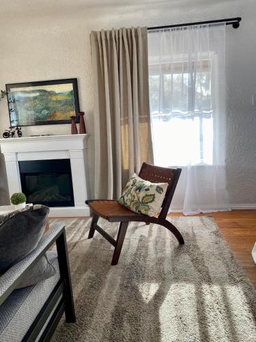 a living room with a chair and a fireplace at Casita Needles with Jacuzzi, Firepit, Boat Parking in Needles