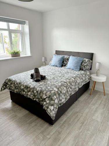 a bedroom with a bed with a dog laying on it at Flat 12 Palm Court in Bournemouth