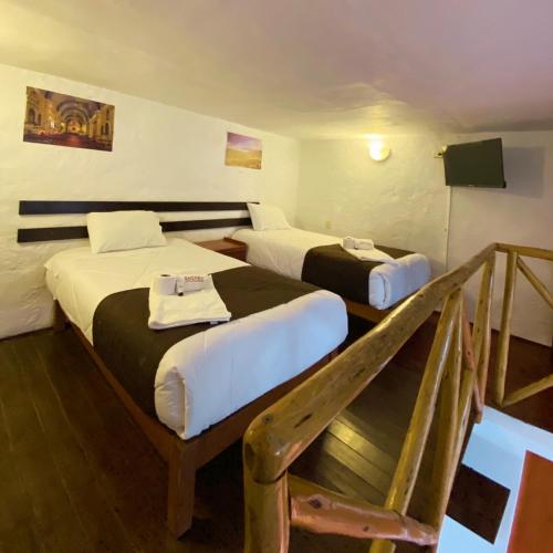 a hotel room with two beds and a staircase at La casa de theo in Arequipa