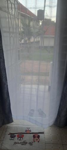 an open window with a view of a yard at Palmview studio in Eldoret