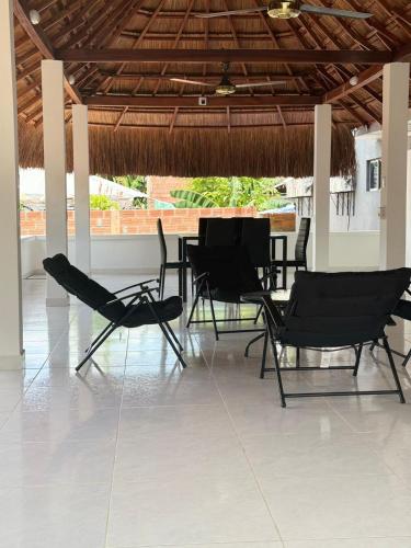 a group of chairs and tables in a pavilion at Hotel barajas in Plazabonita