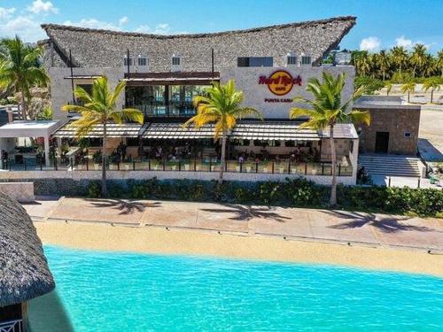 a resort with a swimming pool in front of a building at Downtown Punta Cana Vibrant Apartment! in Punta Cana
